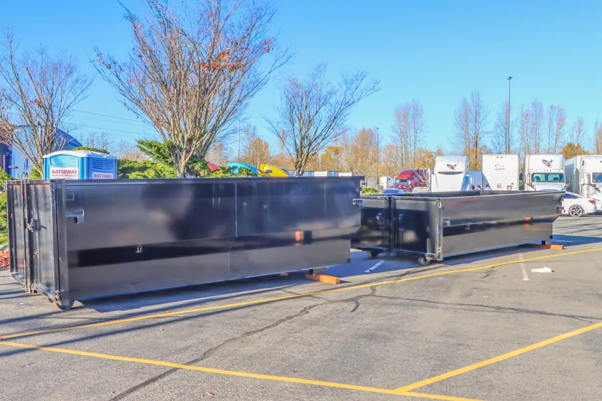 Professional dumpster rental service with roll-off container on residential driveway in Owings Mills